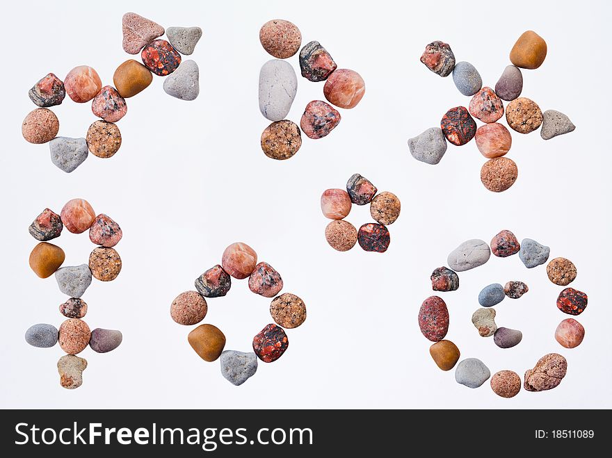 Set of signs and bullet points made of pebble on white background.