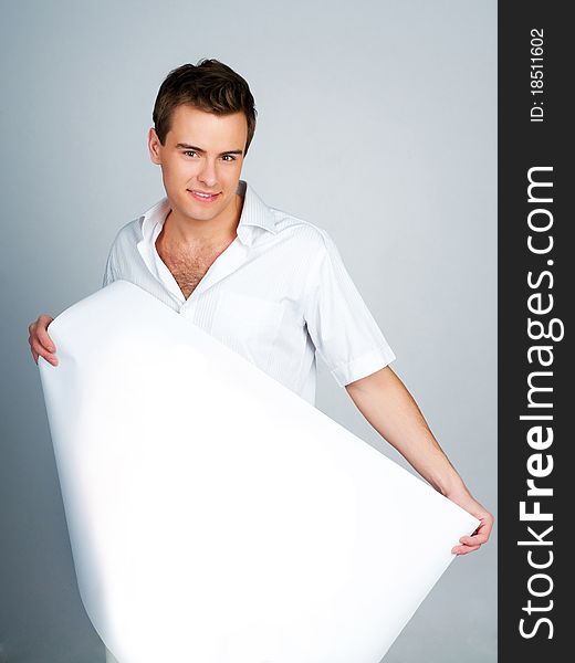 Handsome young man holding a paper