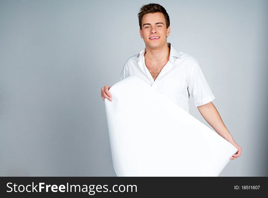Handsome young man holding a paper