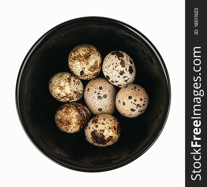 Black plate with quail eggs, top view