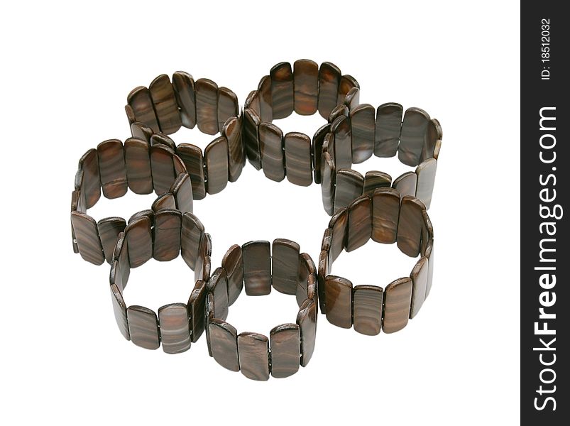 Color photograph of silver and wooden bracelets with a white background