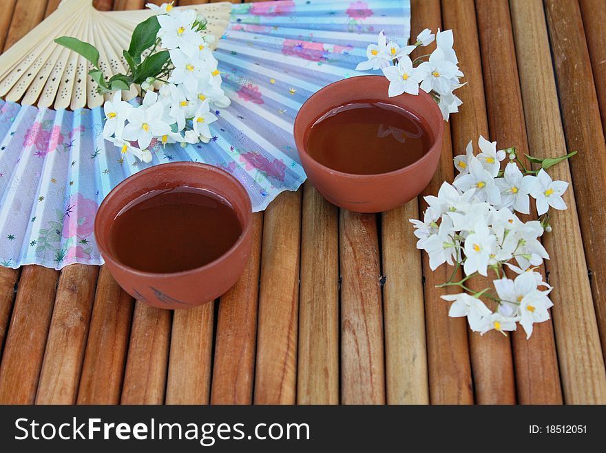 Two teacups with jasmine blossoms. Two teacups with jasmine blossoms