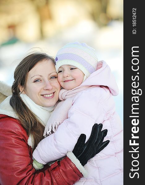 Young mother with her daughter. winter day. Young mother with her daughter. winter day