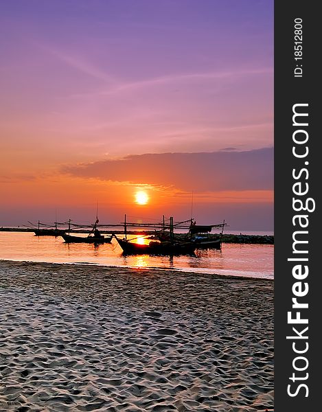 Fishing boats and sun rise with violet sky