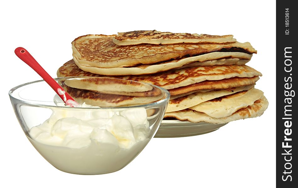 Pancakes and bowl with sour cream isolated on a white background. Pancakes and bowl with sour cream isolated on a white background