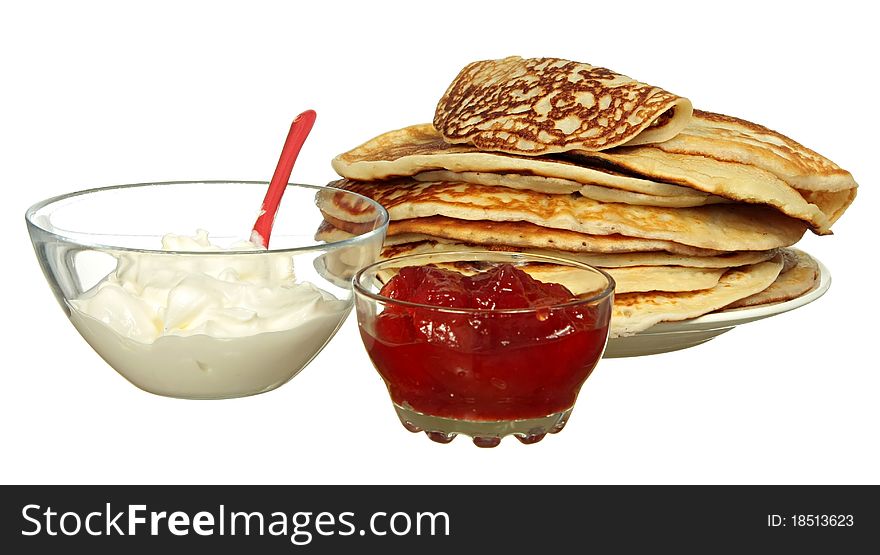 Pancakes and bowl with sour cream isolated on a white background. Pancakes and bowl with sour cream isolated on a white background