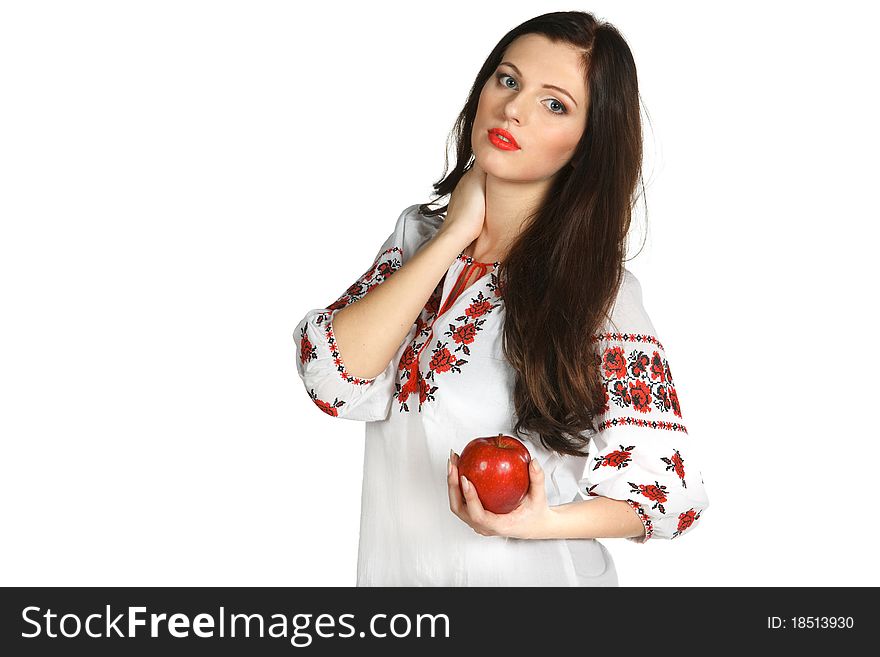 Young female in embroidery chemise holding red apple isolated on white