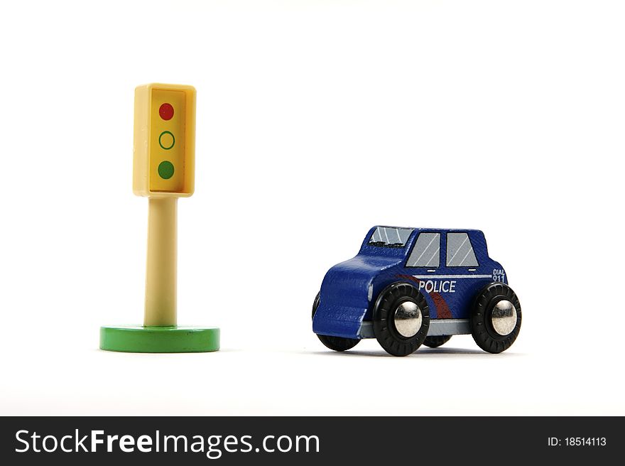 Toy stop light and police car on white background