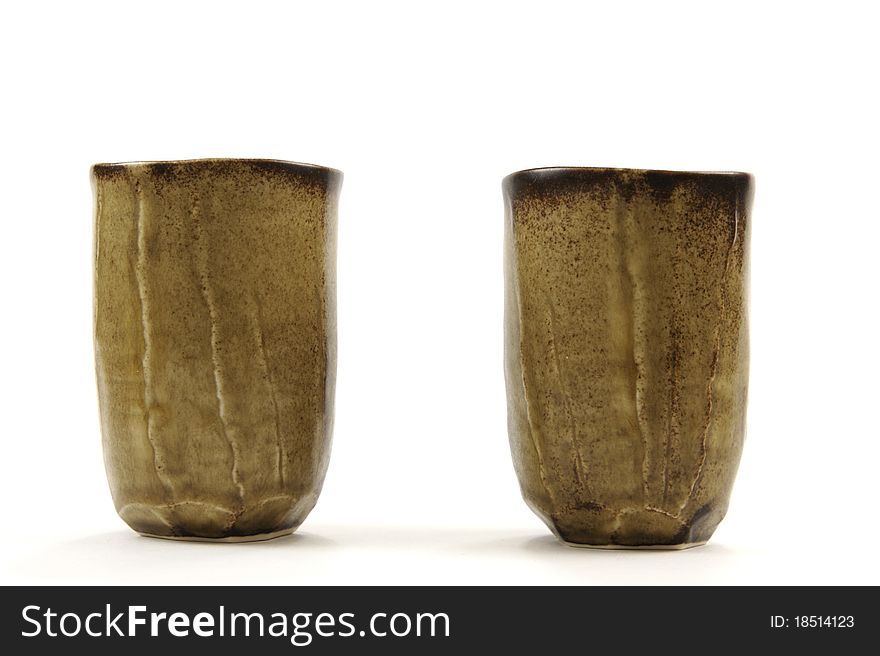 Two brown tea cups on white background. Two brown tea cups on white background