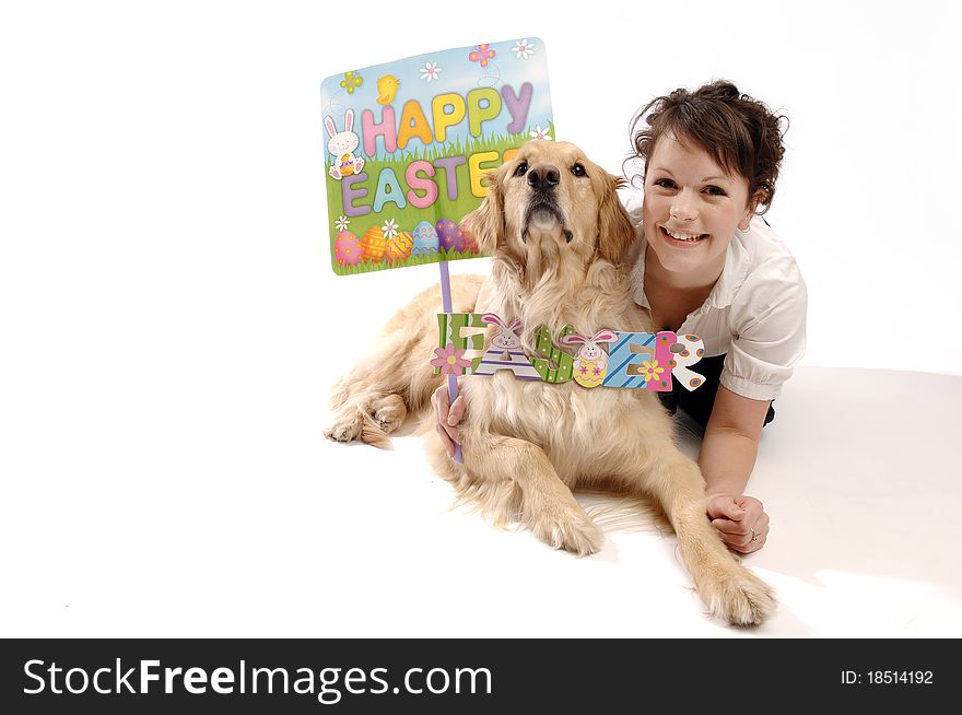 Young pretty woman and her dog hold Easter sign. Young pretty woman and her dog hold Easter sign.