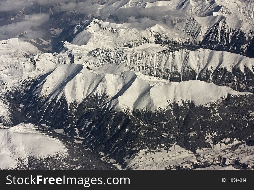 Photo taken from the airplane, somewhere above Alps during winter time. Photo taken from the airplane, somewhere above Alps during winter time.