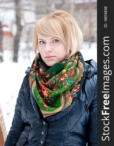 Frozen beautiful woman in winter clothing outdoors