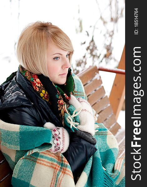 Frozen beautiful woman in winter clothing outdoors