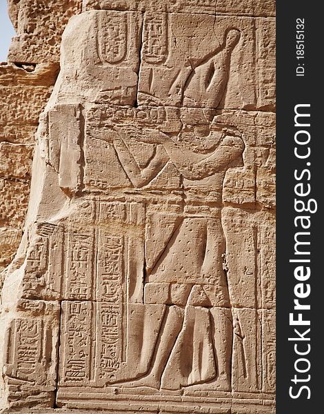 Egyptian images and hieroglyphs engraved on stone in Horus temple, Edfu, Egypt