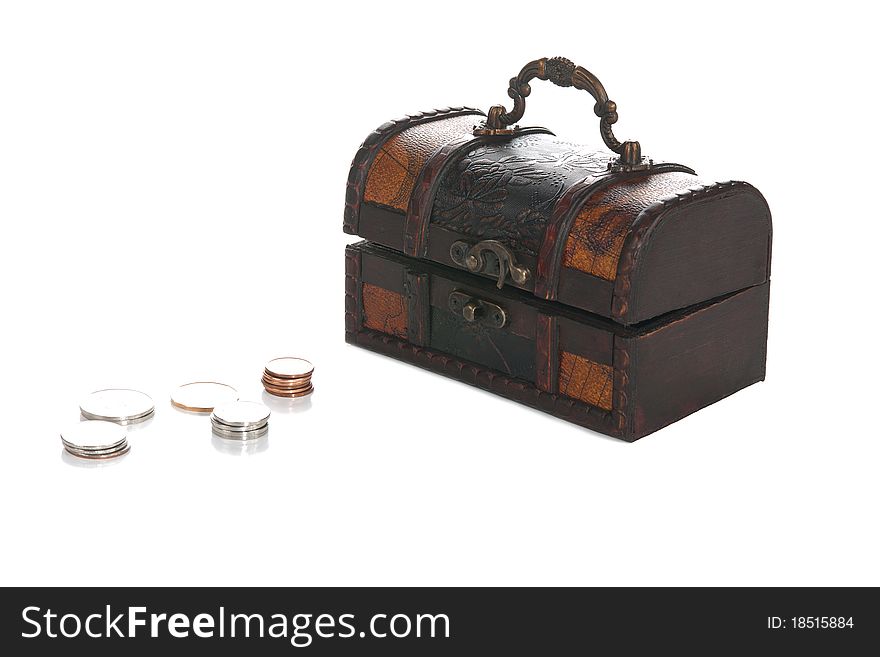 A front studio isolation shot on a white background of a small pirate chest withs some coins. A front studio isolation shot on a white background of a small pirate chest withs some coins.