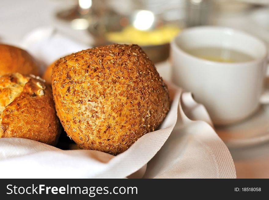 Freshly baked bread and buns with other breakfast utensils.