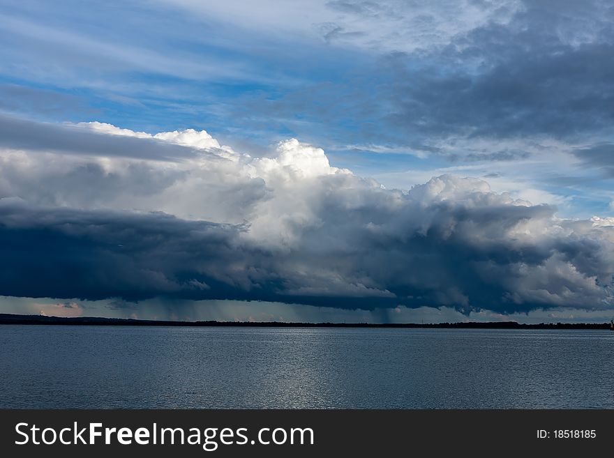 Big powerful storm clouds over the lake