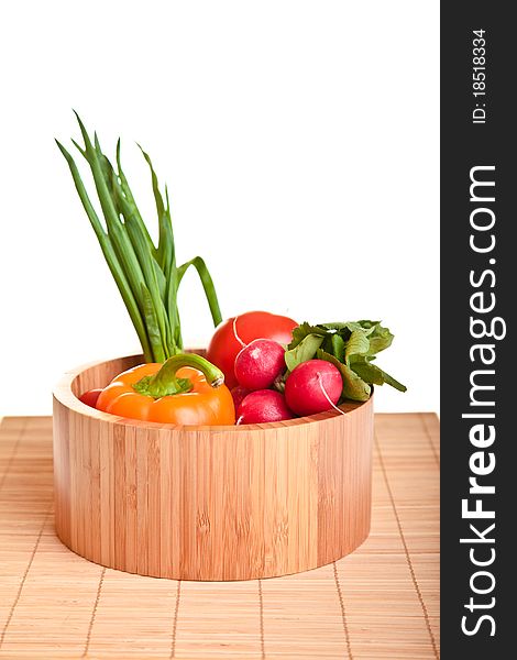 Different ripe vegetables composition in studio laying on bamboo plate