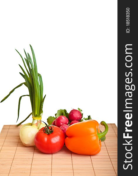 Different ripe vegetables composition in studio laying on bamboo plate