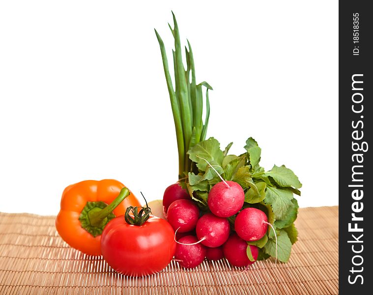 Different ripe vegetables composition in studio laying on bamboo plate