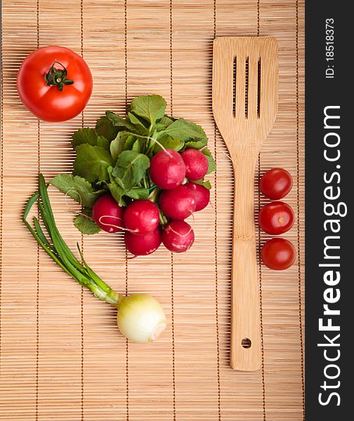 Different ripe vegetables composition in studio laying on bamboo plate