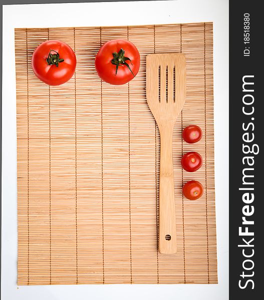 Different ripe vegetables composition in studio laying on bamboo plate