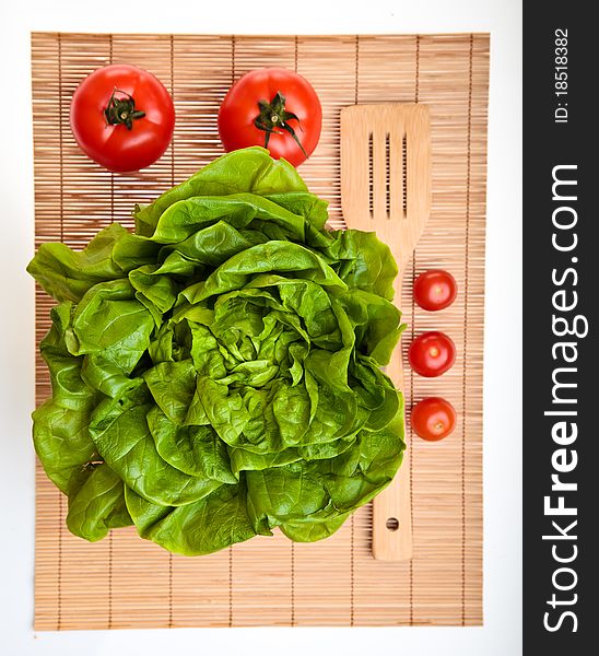 Different ripe vegetables composition in studio laying on bamboo plate