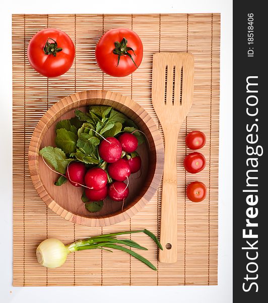 Different ripe vegetables composition in studio laying on bamboo plate