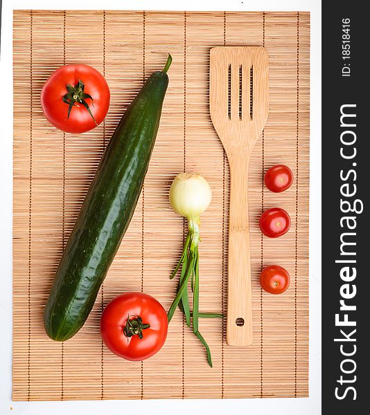Different ripe vegetables composition in studio laying on bamboo plate