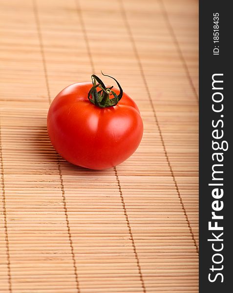 Different ripe vegetables composition in studio laying on bamboo plate