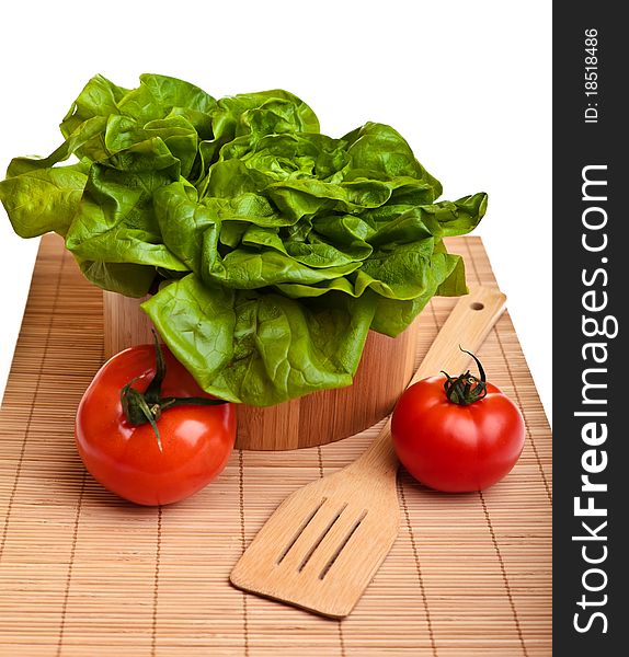 Different ripe vegetables composition in studio laying on bamboo plate