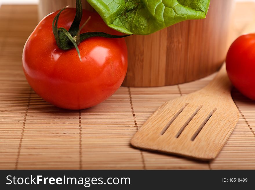 Different ripe vegetables composition in studio laying on bamboo plate