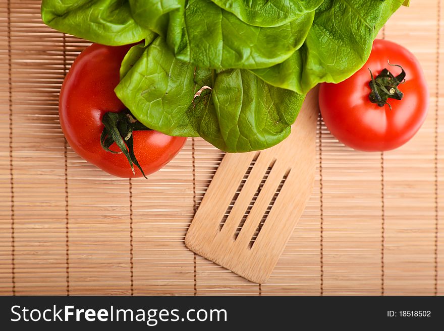 Different ripe vegetables composition in studio laying on bamboo plate