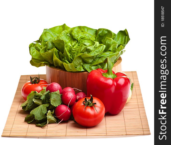 Different ripe vegetables composition in studio laying on bamboo plate