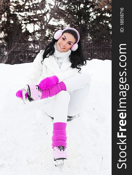 Happy beautiful girl wearing warm winter clothes ice skating. Happy beautiful girl wearing warm winter clothes ice skating