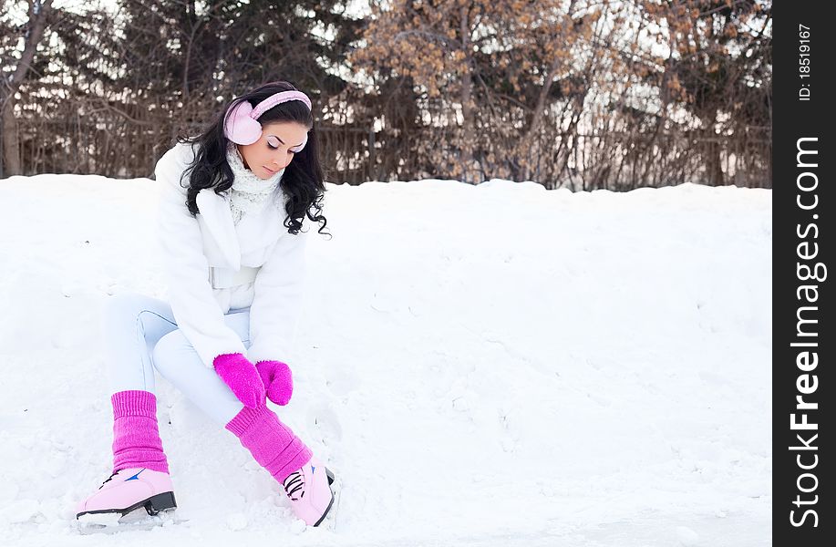 Happy beautiful girl wearing warm winter clothes ice skating. Happy beautiful girl wearing warm winter clothes ice skating