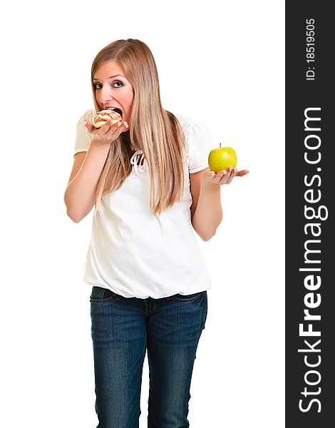 Woman choosing apple over puff cookie isolated on white