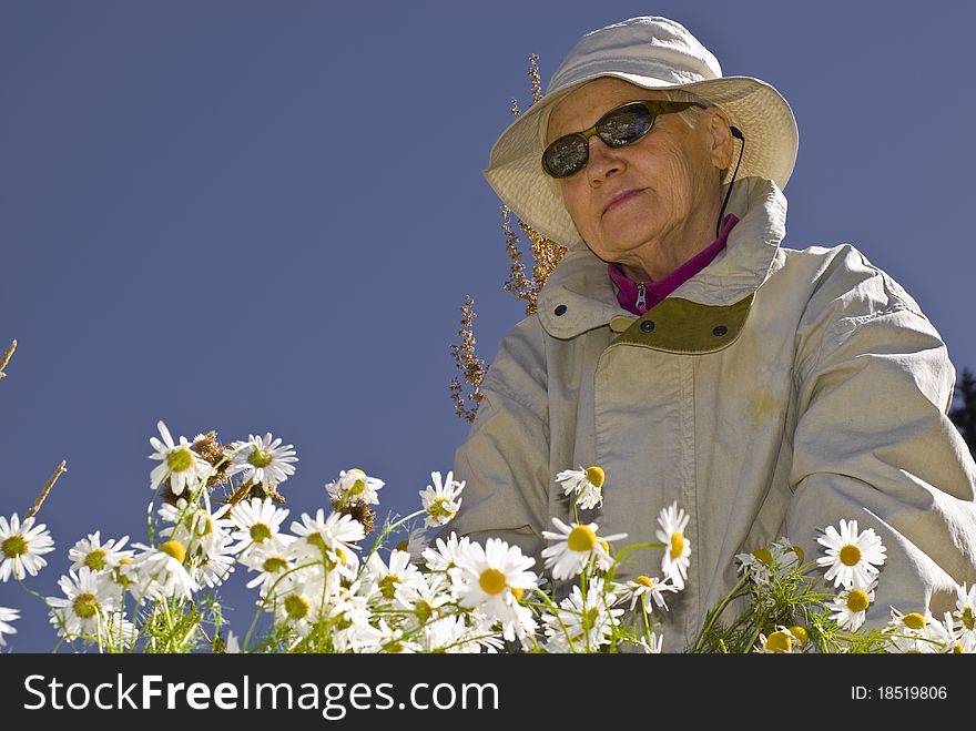 Old women with moutains flowers. Old women with moutains flowers