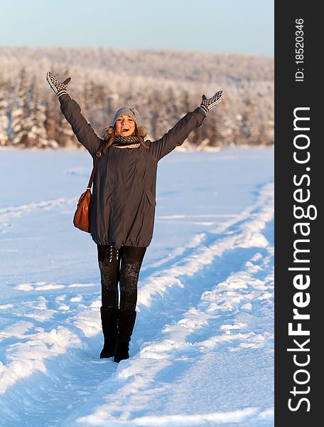 Portrait of a beautiful young girl in the sunlight in the cold