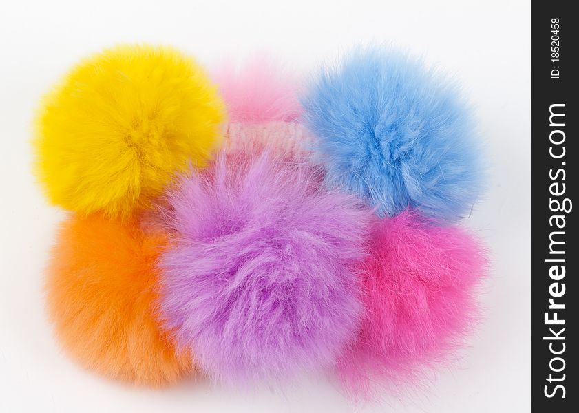 Fur hair-slide from the colored balls on a light background