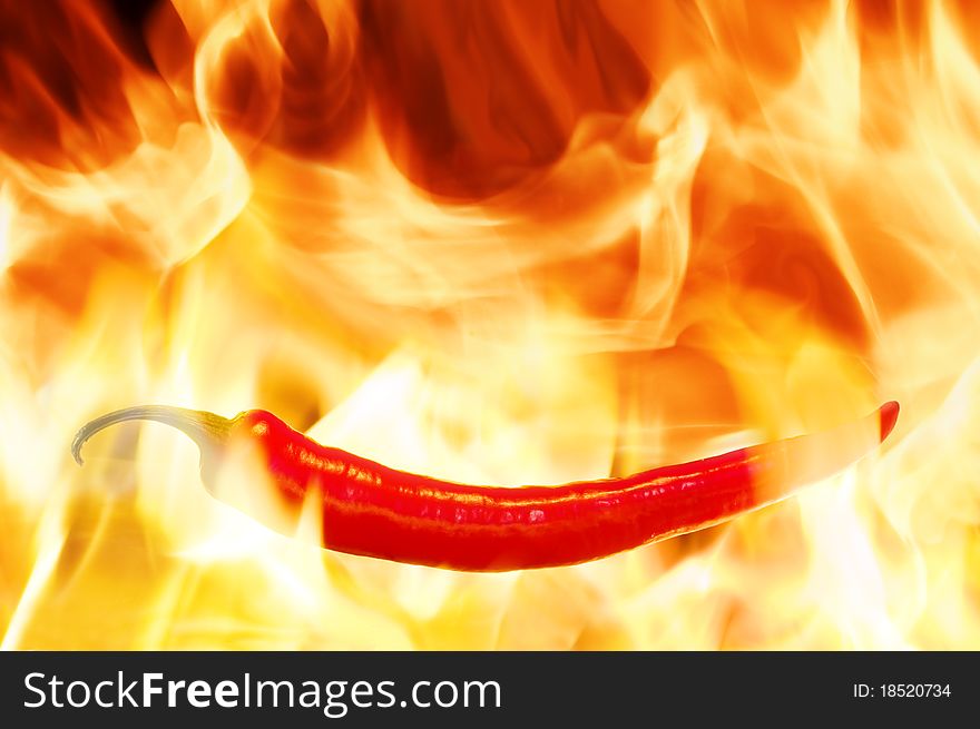 Red pepper on flame closeup