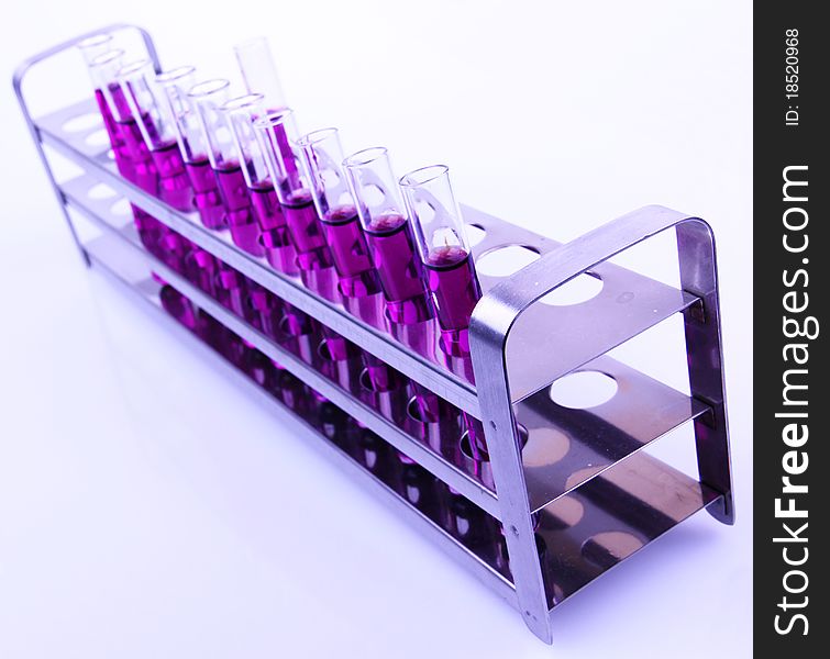 Studio photo of vials with purple liquid samples. Studio photo of vials with purple liquid samples