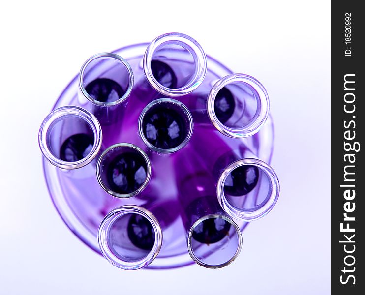 Studio photo of vials with purple liquid samples.Top view. Studio photo of vials with purple liquid samples.Top view