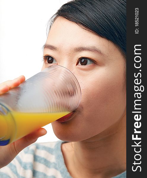 Woman drinking orange juice isolated on white