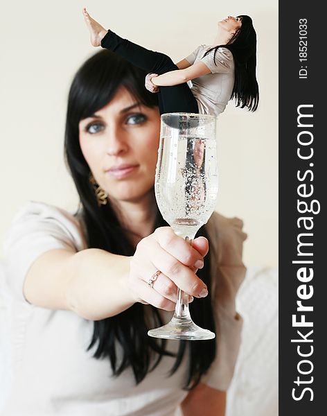 Woman having in her hand a glass with herself in it. Woman having in her hand a glass with herself in it