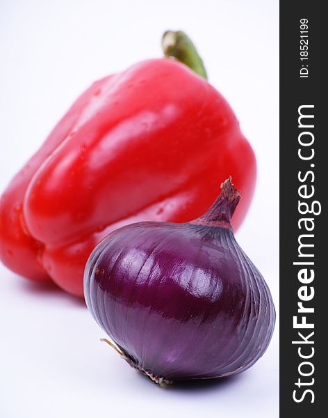 Pepper and violet onion isolated over white. Pepper and violet onion isolated over white