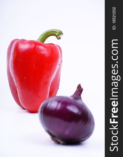 Pepper and violet onion isolated over white. Pepper and violet onion isolated over white