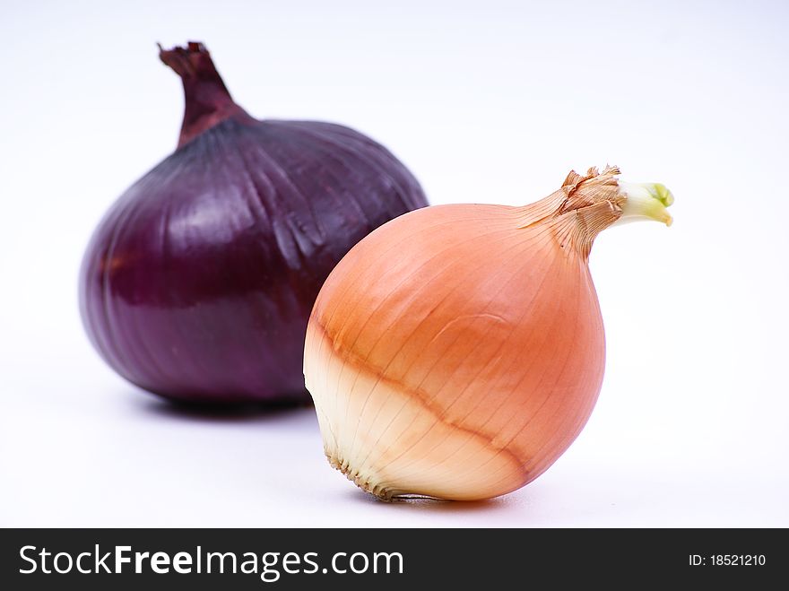 Image of two different onions on a white