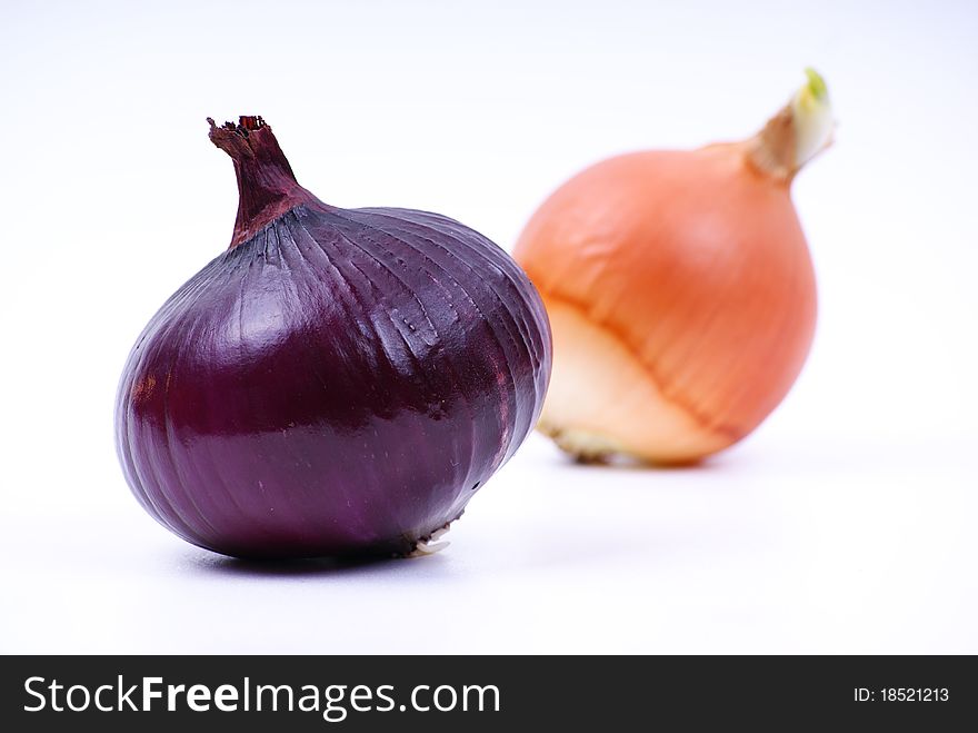 Image of two different onions on a white