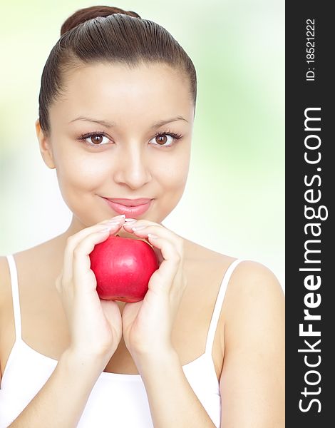 Girl holding red apple on green background. Girl holding red apple on green background